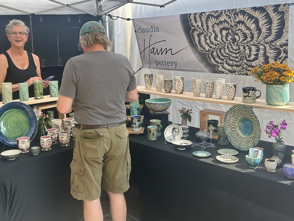 Custom festival booth banner for ceramic artist Claudia Haun at Art in Autumn in Weaverville, North Carolina