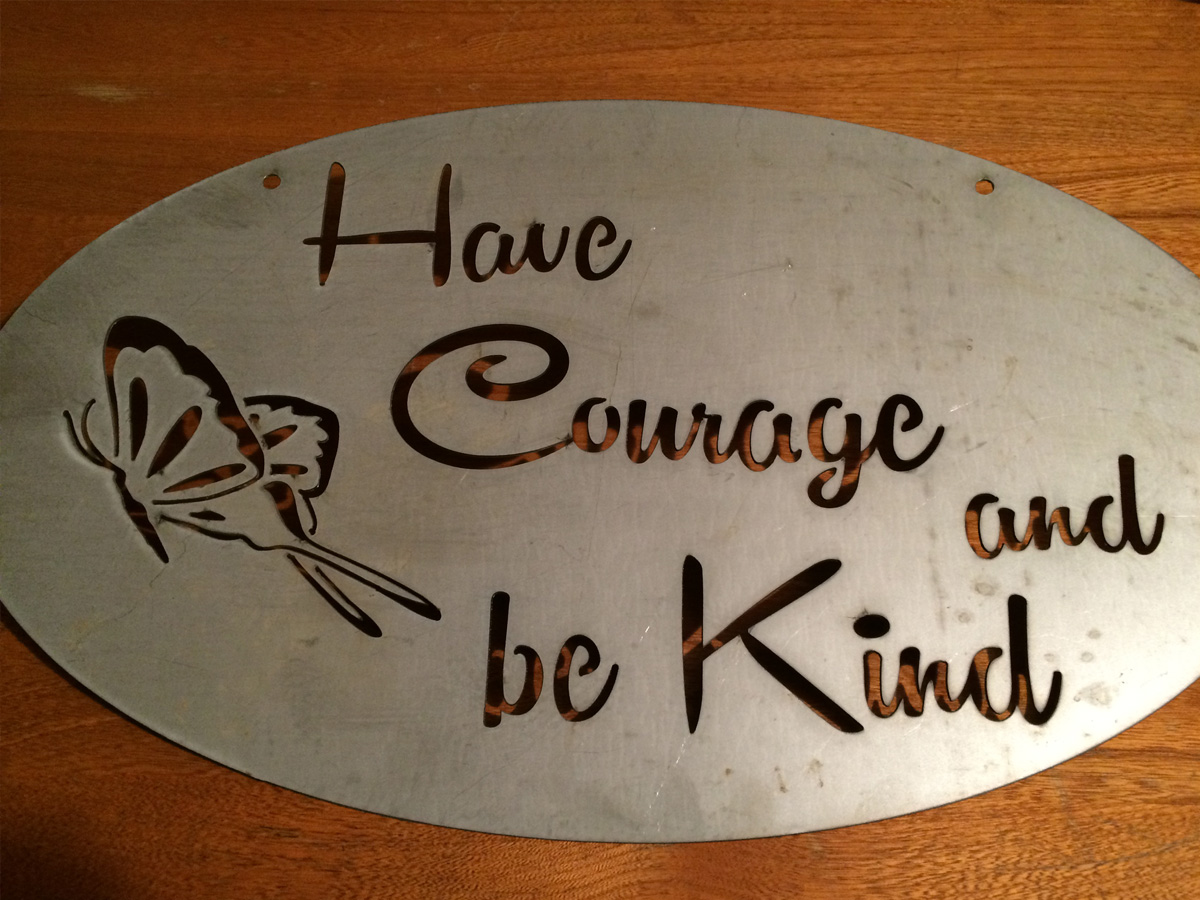 Custom oval steel wedding gift sign reading Have Courage and Be Kind with butterfly cutout