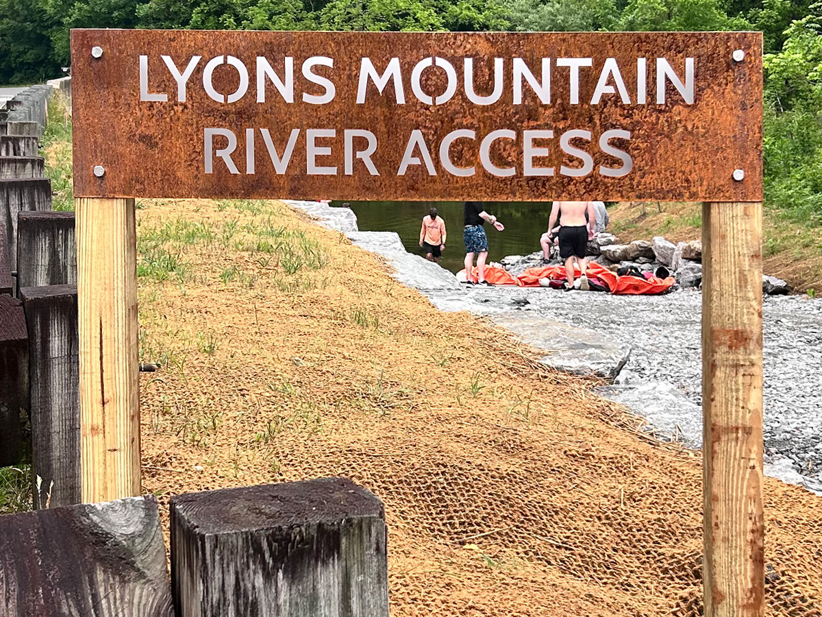 Lyons Mountain River Access rusted steel sign mounted on wood posts in Brevard North Carolina