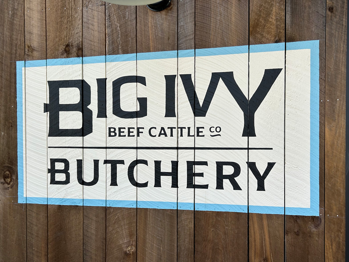 Hand-painted Big Ivy Beef Cattle Company Butchery mural on rough barnwood in Barnardsville North Carolina