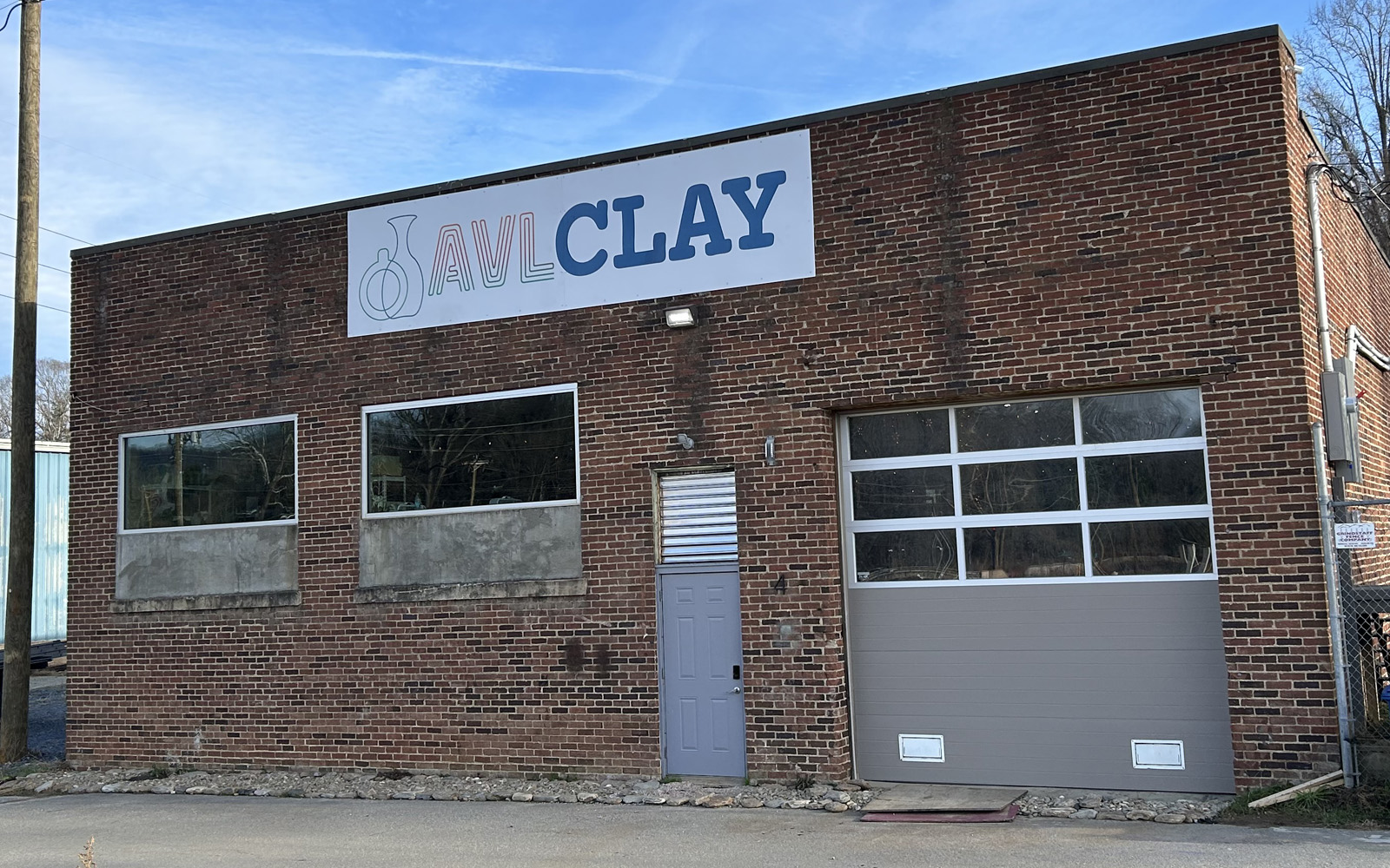 Custom storefront sign designed and installed by Asheville Signworks